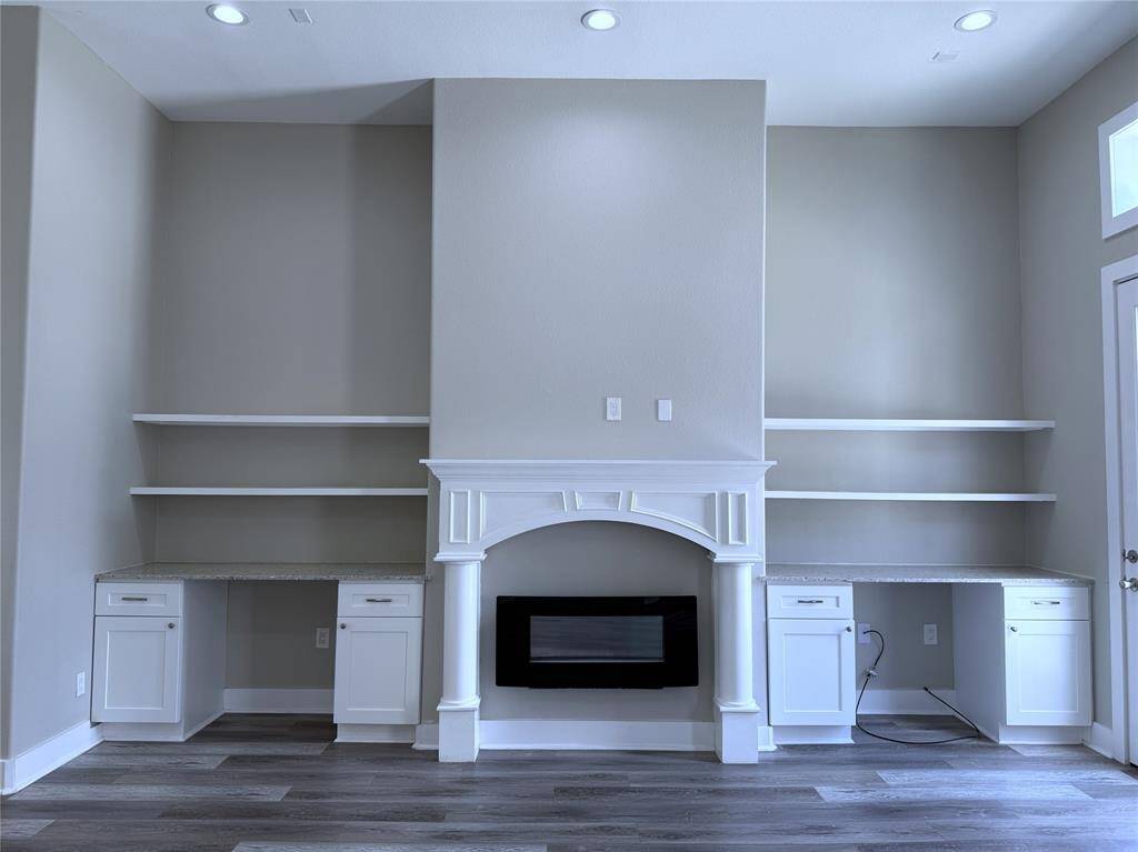 Twin built-in desks & electric fireplace. Perhaps you would like to utilize one or both of the desks as bar space?