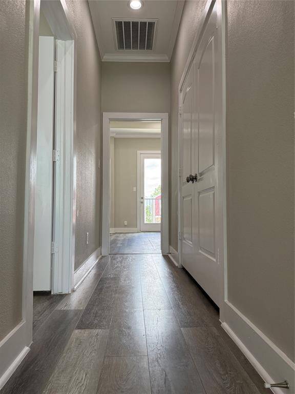 On the 3rd floor, the door on the left opens into a secondary bedroom. On the right, double doors open from the laundry closet. The primary suite is directly ahead.