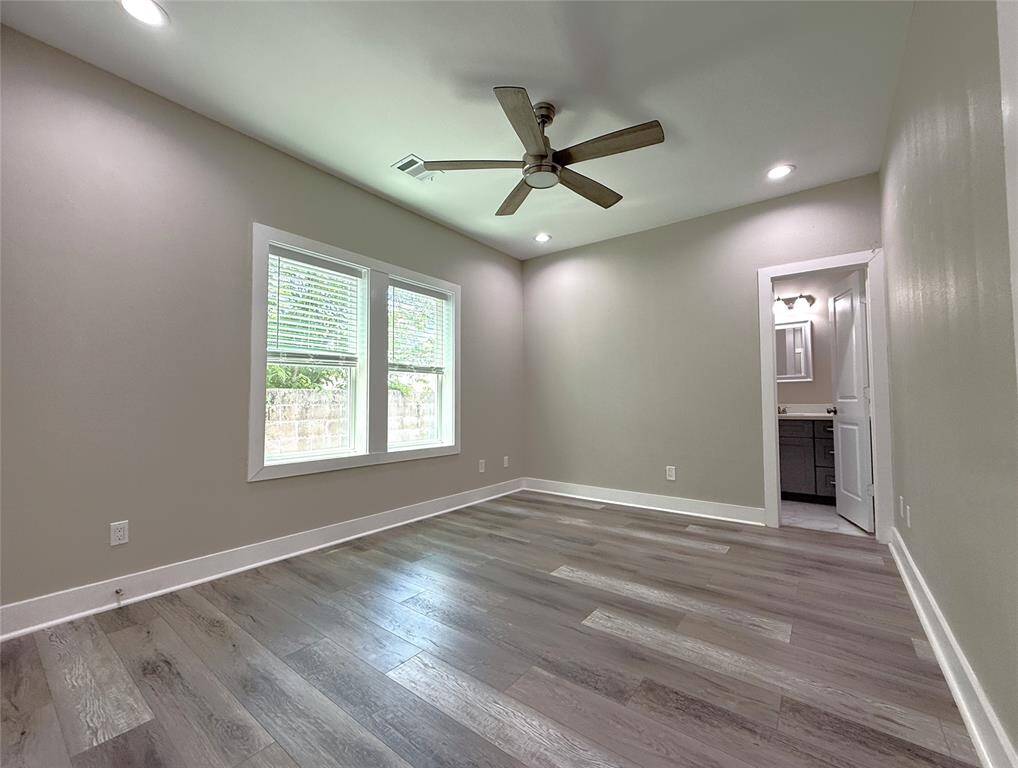 The first floor bedroom offers a ceiling fan, recessed lighting & an en-suite bath.