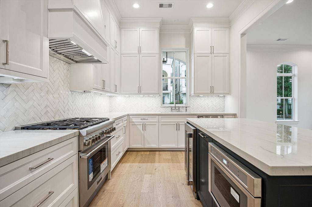 Beautiful, polished quartzite countertops with herringbone backsplash.