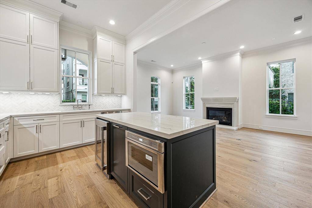 Microwave drawer located on the island along with a wine refrigerator.