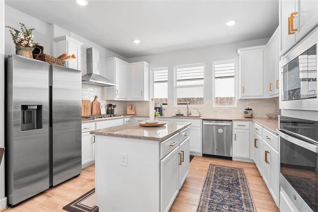 Granite countertops, Island Without a Cooktop, Stainless Steel Appliances, and a 5 Burner Range.