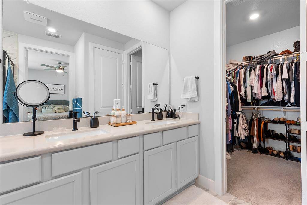 Another view of the primary bathroom and walk-in closet.