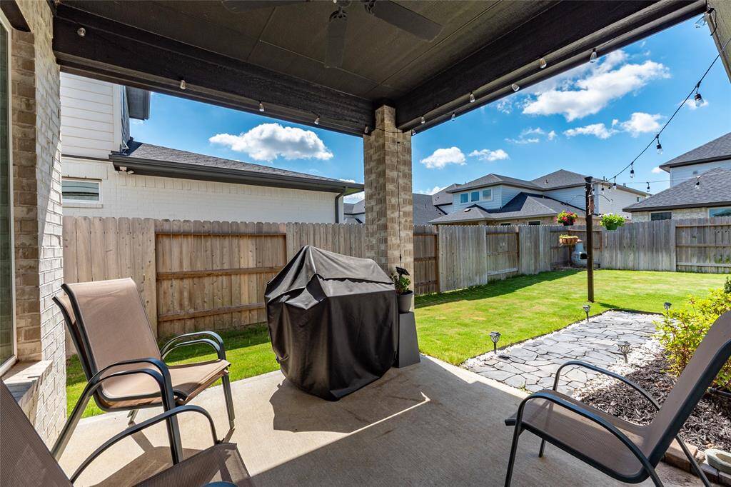 Covered back patio with exterior gas connection for grill.