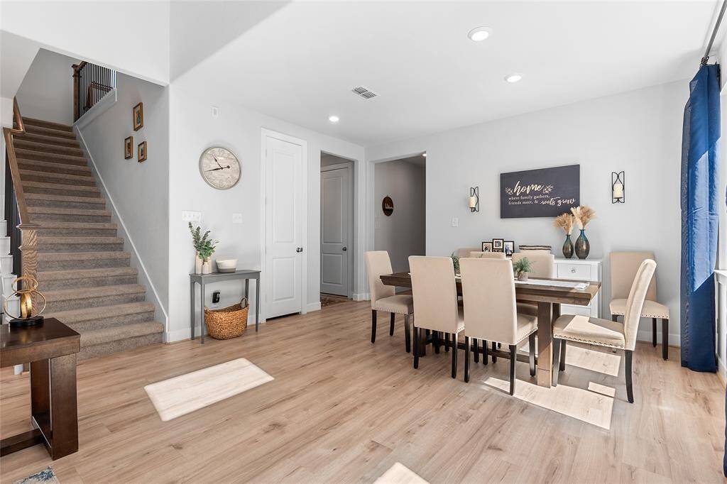 Enjoy a spacious dining area for those larger events and gatherings with family. Recessed lighting throughout. (The left hallway leads to the study and utility. Right leads to the spare bedroom and front door).