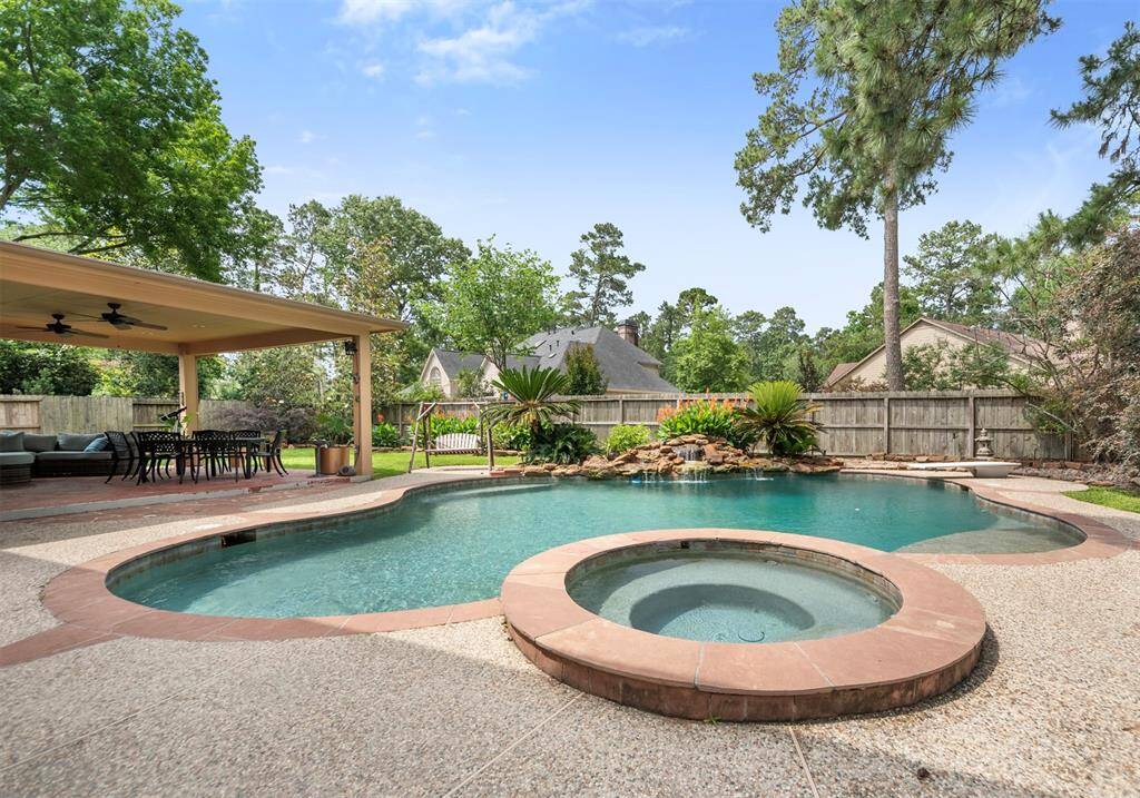 The backyard is incredible with a heated pool, spa and covered patio!