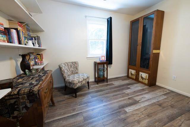 Upstairs bedroom with new flooring, ceiling fan, and new windows.