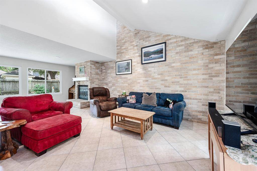 This home displays plenty of charm/character. Living room features a brick wall accent, tile flooring, fire place, and windows allowing in natural light.