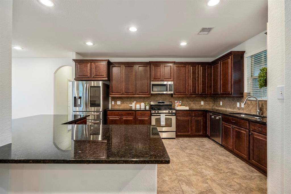 Spacious kitchen with abundant cabinetry and a large island.