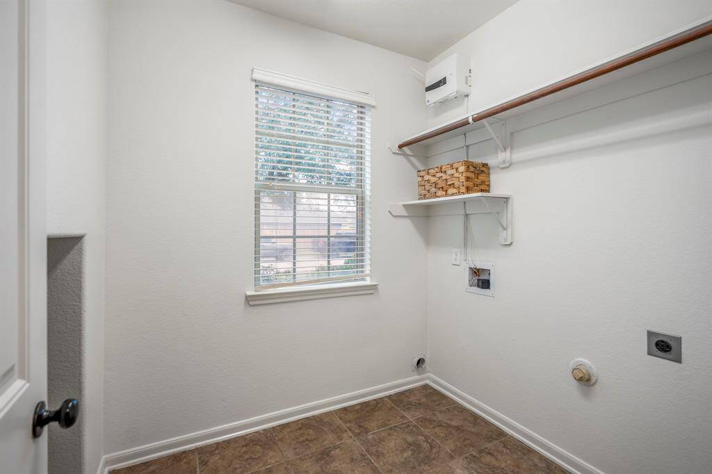 Bright and airy laundry room with natural light downstairs.