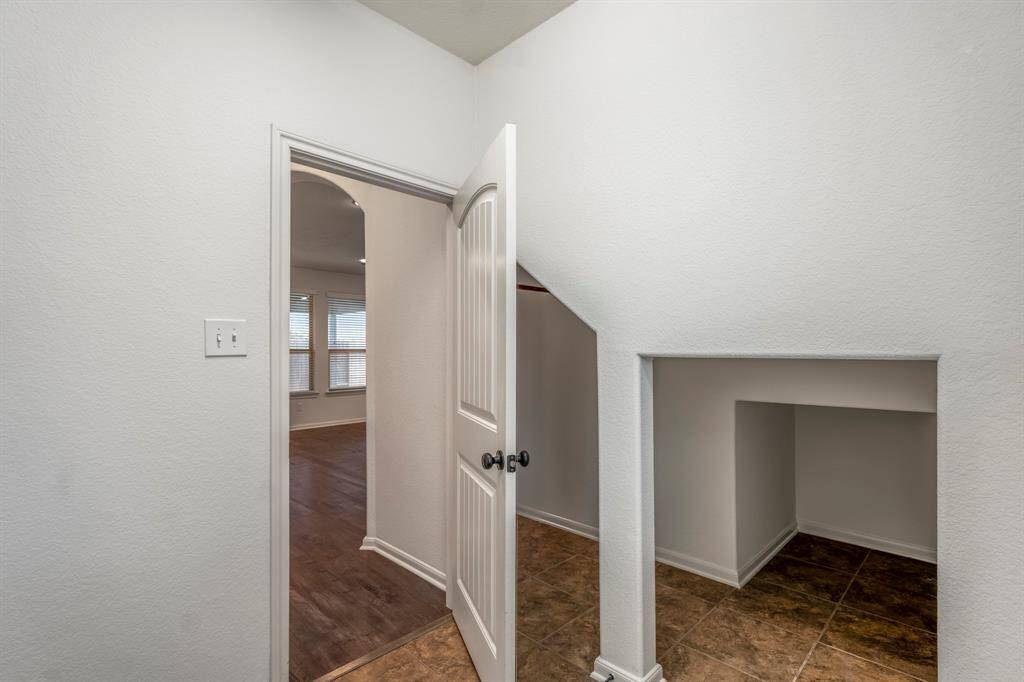 This clever coat closet features a convenient passage to the laundry room.