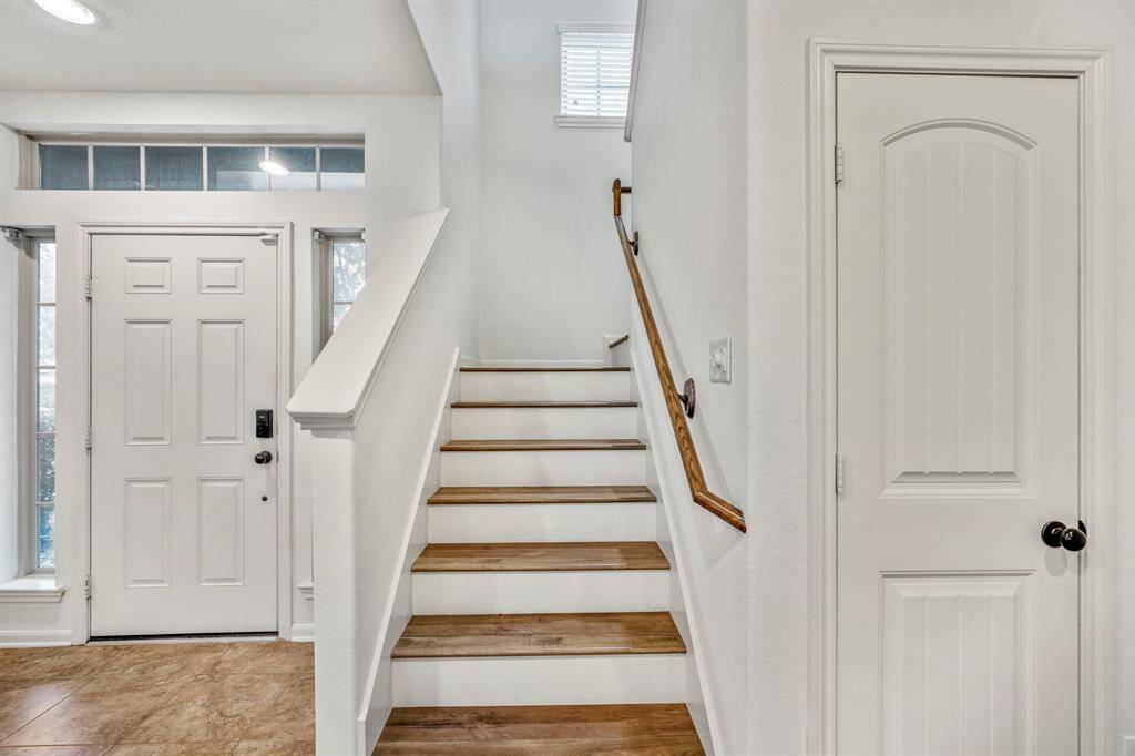 Explore the inviting upstairs space through this bright and welcoming staircase.
