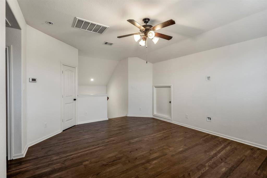 Spacious game room with convenient storage closet and easy attic access.
