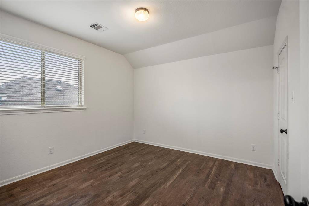 Bright upstairs bedroom with ample natural light.