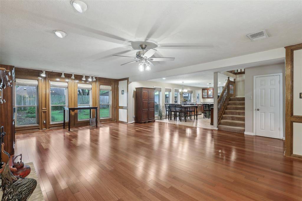 Alternate view of the family room showcasing the seamless flow into the open breakfast room and kitchen, creating a perfect space for family gatherings