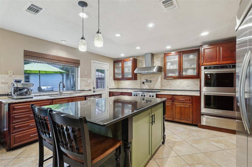 Kitchen view featuring beautiful granite countertops and a large island, offering both style and functionality for cooking and entertaining