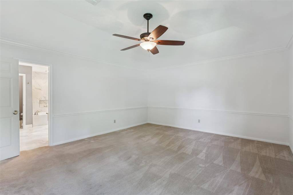 Large, open bedroom with plenty of space, seamlessly leading into the luxurious primary bath for the ultimate retreat experience