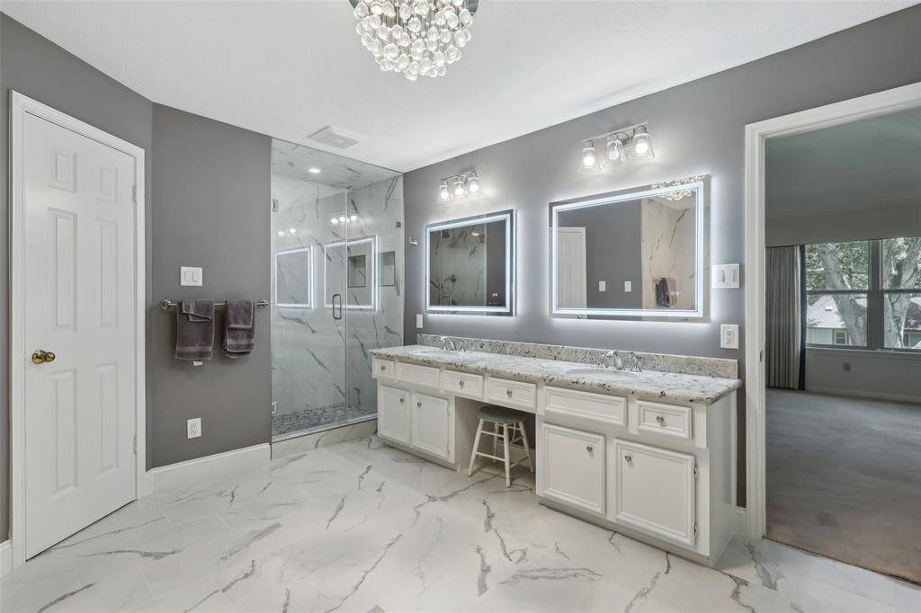 Offering double sinks, sleek mirrors with modern lighting