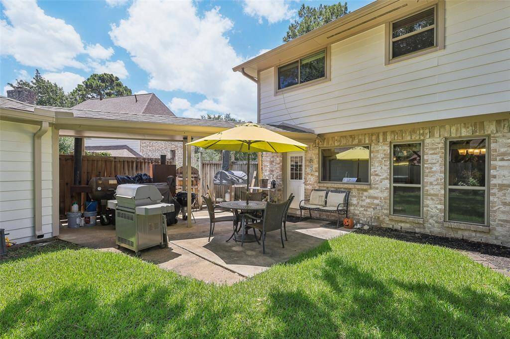 Back view of a sturdy four-sided brick home, situated on a large lot, offering plenty of outdoor space for activities and future possibilities