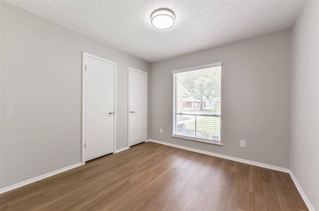 All three secondary bedrooms feature vinyl plank flooring and blinds.