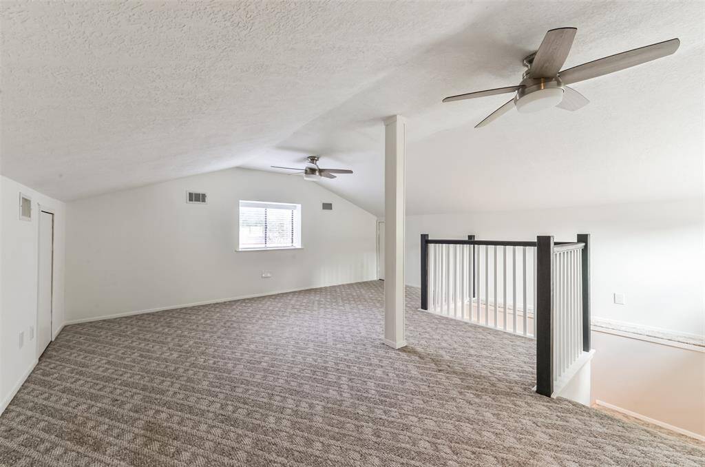 This SPACIOUS GAMEROOM is on the second floor and features modern ceiling fans.