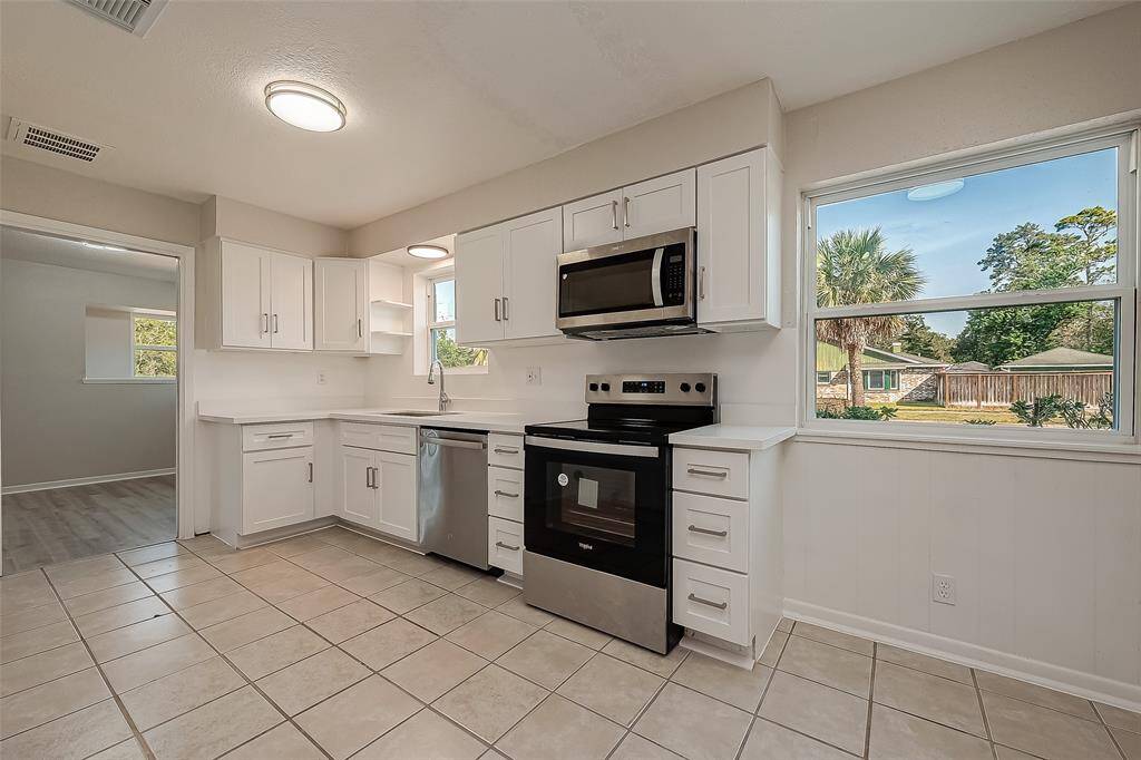 Completely remodeled kitchen equipped with stainless steel appliances and quartz counter tops.