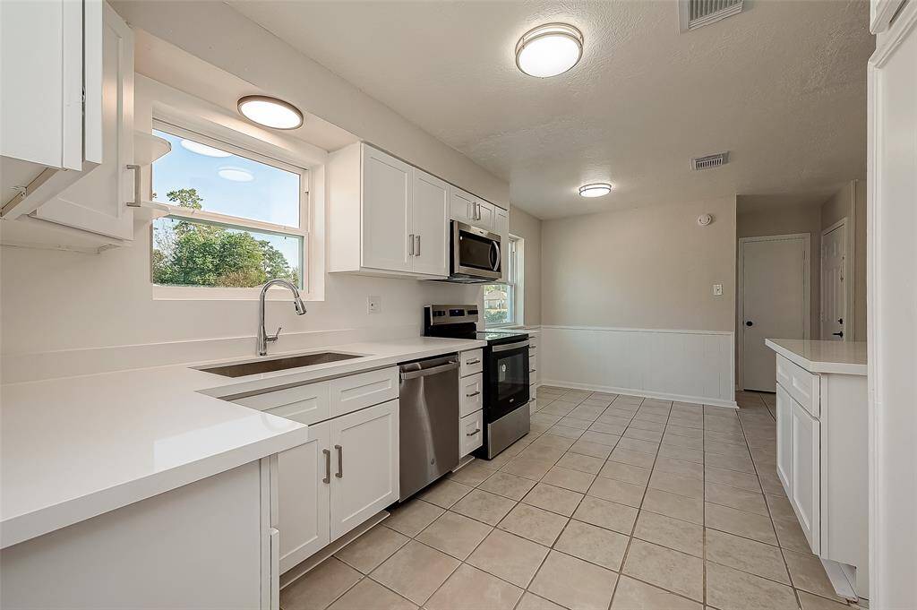 Functional kitchen with ample cabinetry.
