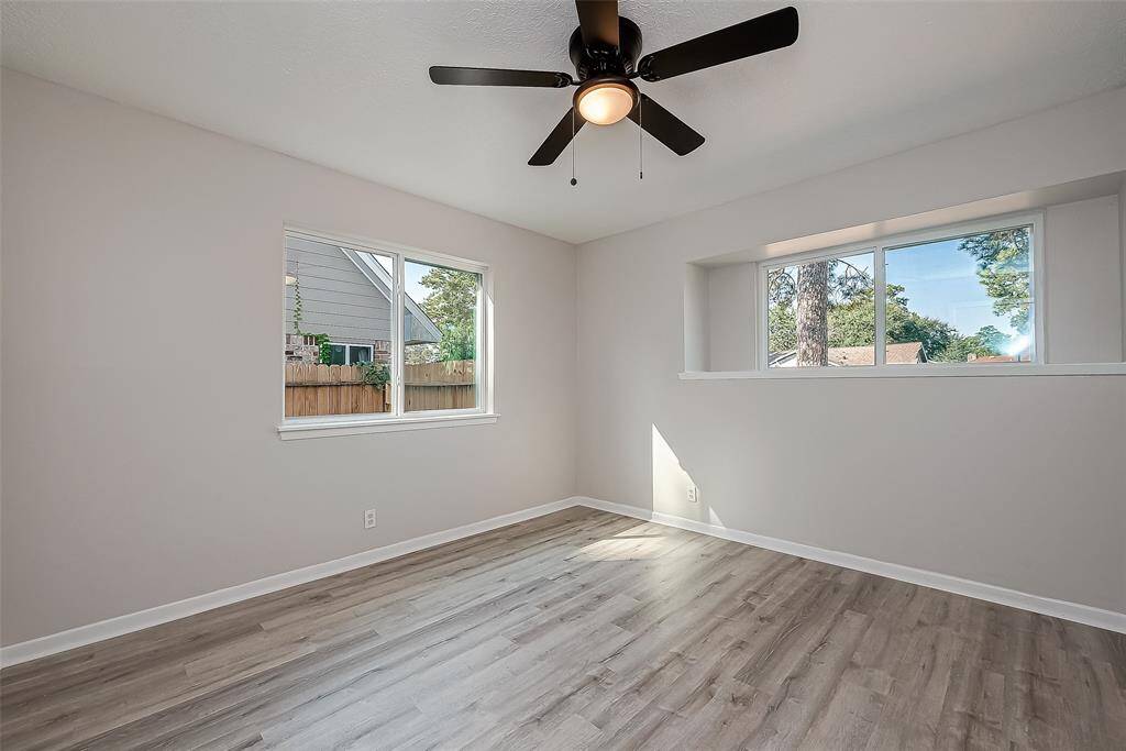 View of secondary bedroom with a front yard view.