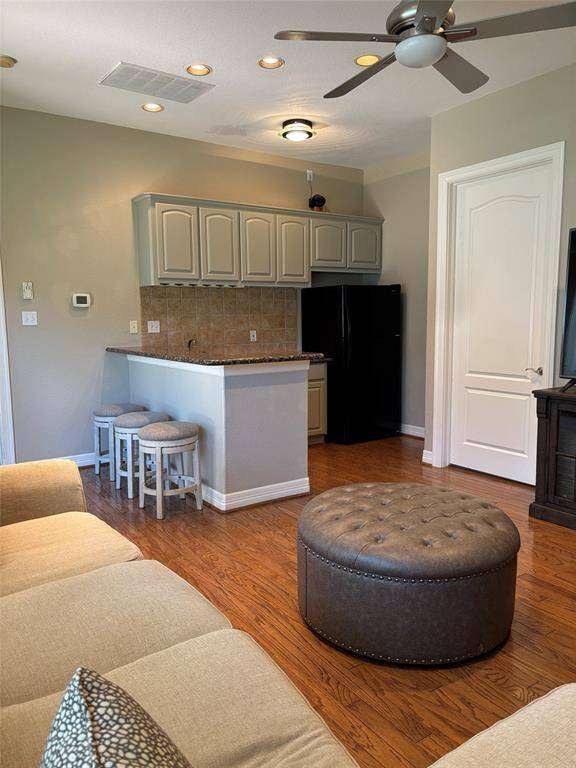 Inviting view from the dining area into a spacious, modern kitchen.