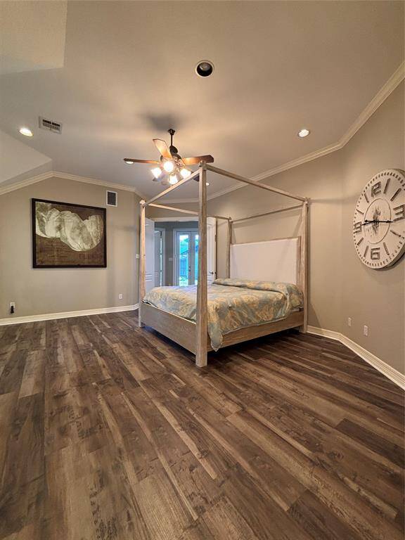 Luxurious spa-inspired bathroom featuring a deep whirlpool soaking tub, perfect for relaxation. The space includes his-and-her vanities, a body spray walk-in shower, and ample cabinetry