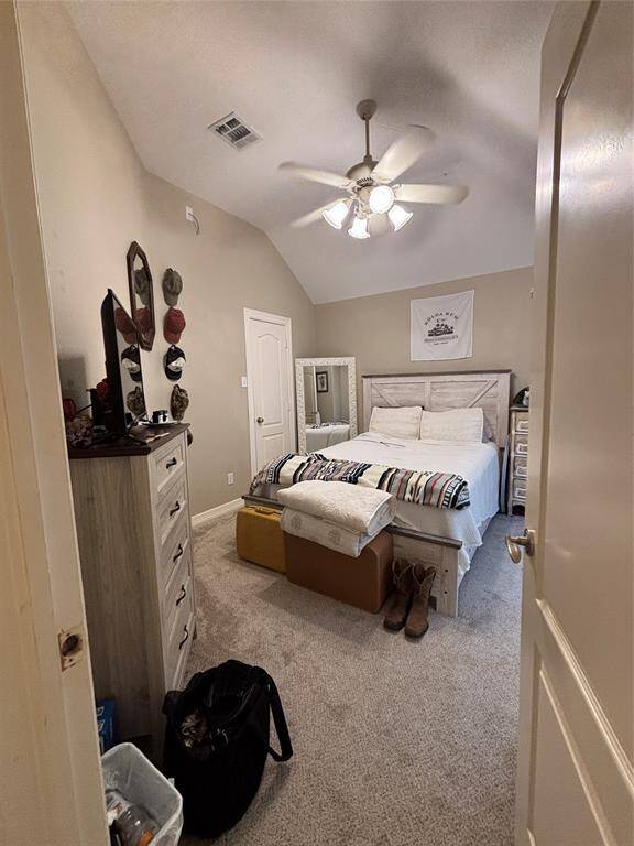 The second bedroom has vaulted ceilings and soft natural light enhance the serene atmosphere