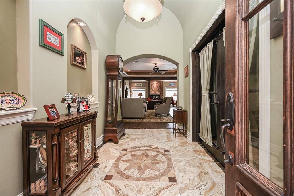 A beautiful foyer...High ceilings, art niches and marbled travertine.