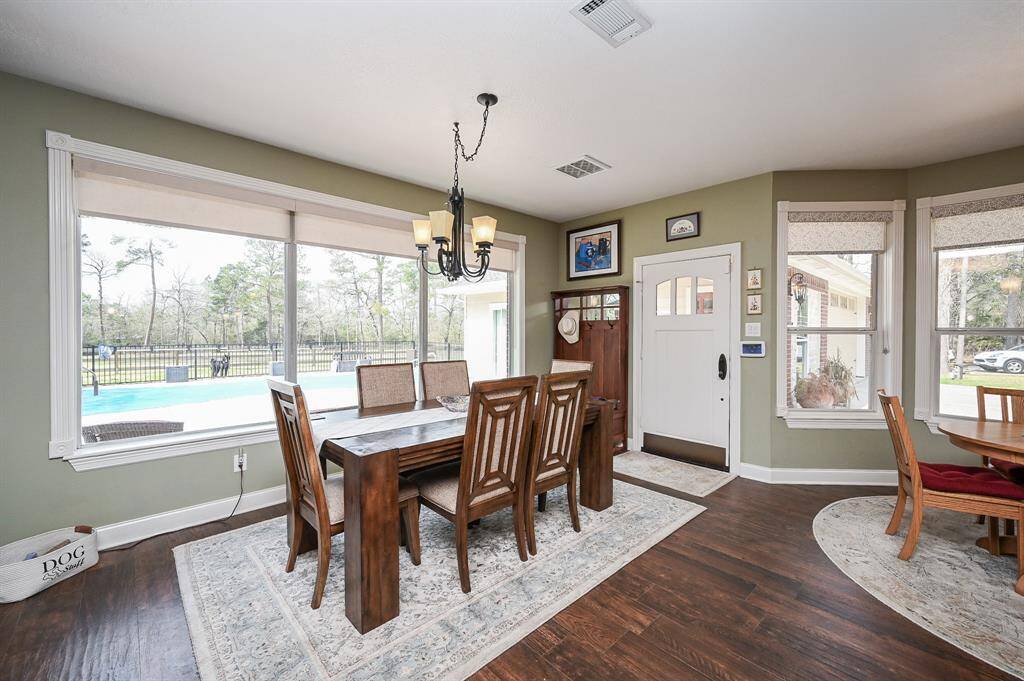 Dining room is open to the kitchen and living. Views of the back yard and pool area.