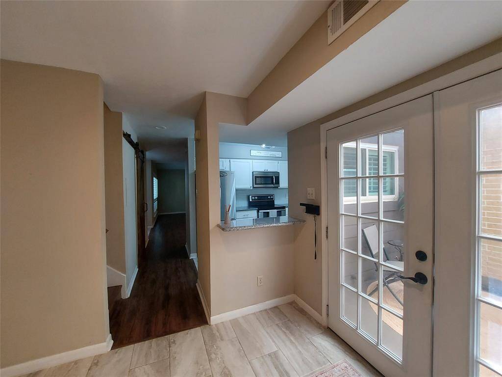 This picture shows a small pass thru bar for your dining area and the french door going into the back patio!