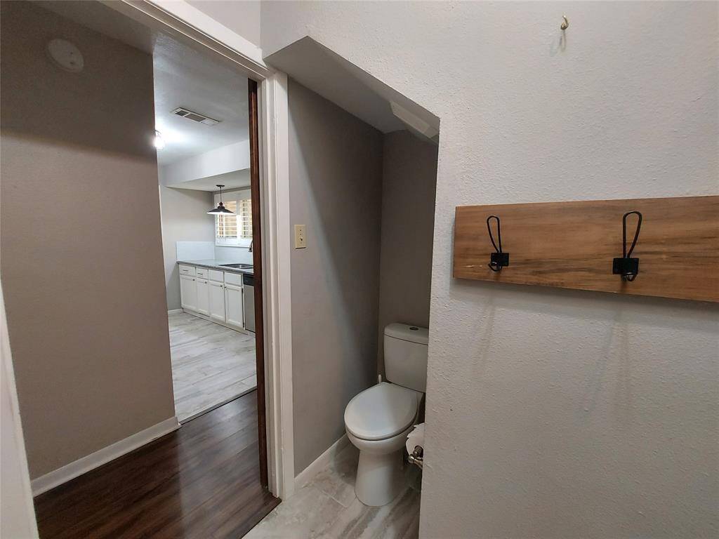 This view is from the half bath and the utility room looking into the hall and the kitchen!
