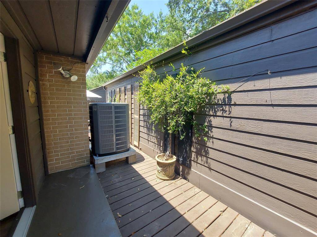 This townhome comes with a new complete AC system . Inside and out!  The back private patio shows potted  plant with trellis. This stays with the townhome too!!