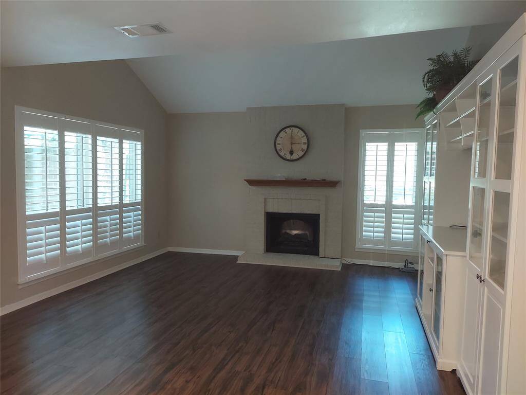 Can you see your furniture in this lovely cozy living room sitting by the fireplace? custom shutters and recently installed Low E vinyl windows.