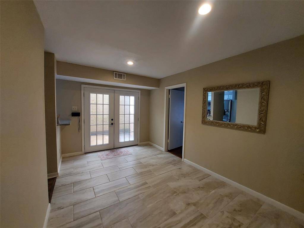 Beautiful Tile in the Dining room which opens with french doors to your own private patio.