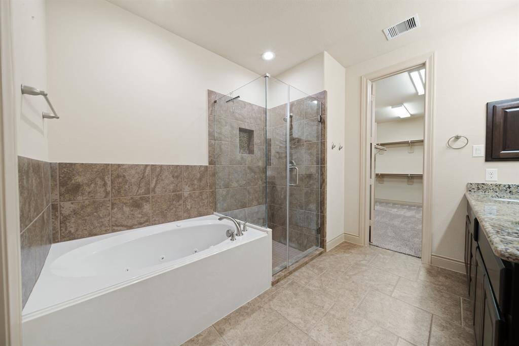 Jetted tub with separate seamless shower and a spacious walk-in closet!