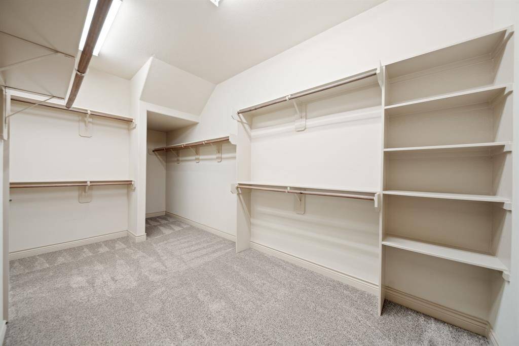 Spacious walk in closet with access to the laundry room!