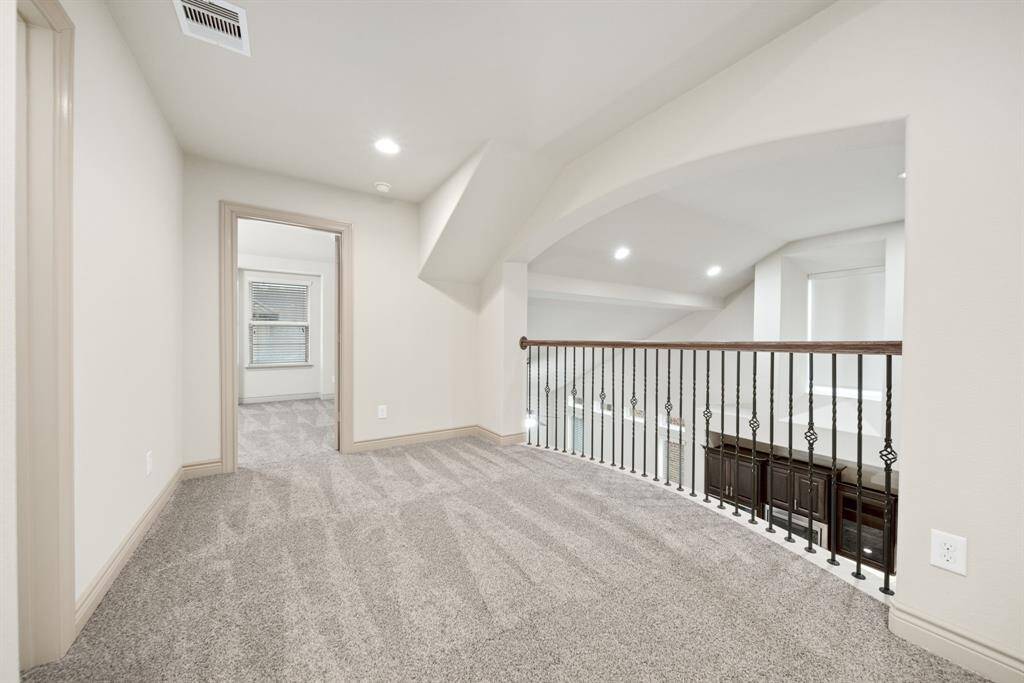 Stunning catwalk feature with wrought iron details, leading to the secondary bedroom upstairs!