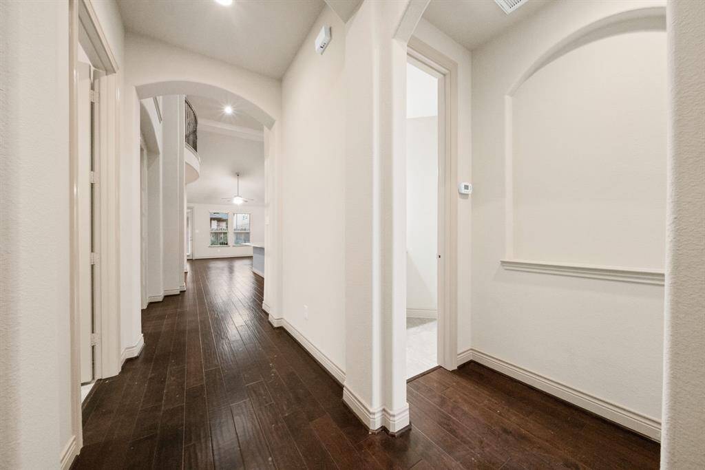 Appreciate details like wood flooring, arched entryways, soaring ceilings and art niches throughout the home!
