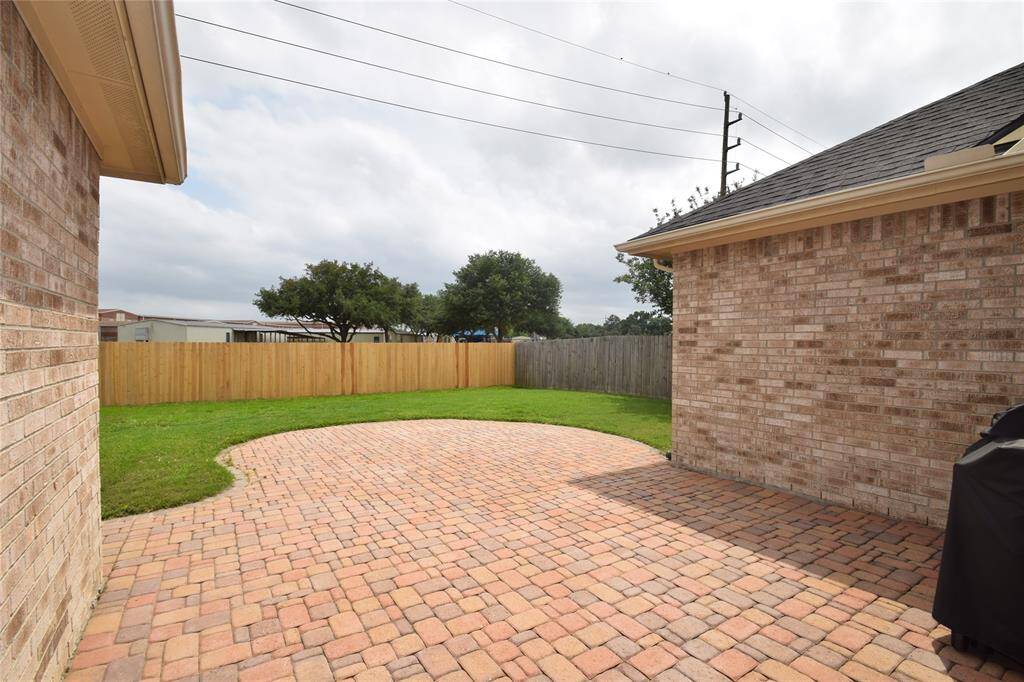 Patio area overlooking the fully fenced backyard.