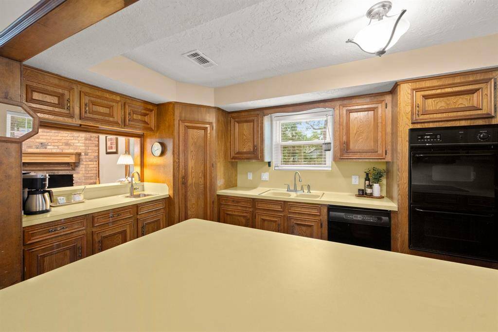 Coffee or beverage bar to the left is open to the family room and includes a small prep/vegetable sink.