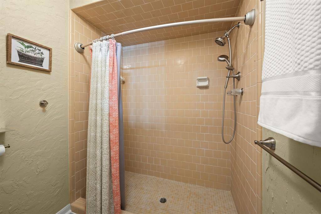 Large walk-in shower in the primary ensuite includes full tile surround and overhead, a mud-set floor, shower head and body sprayer.