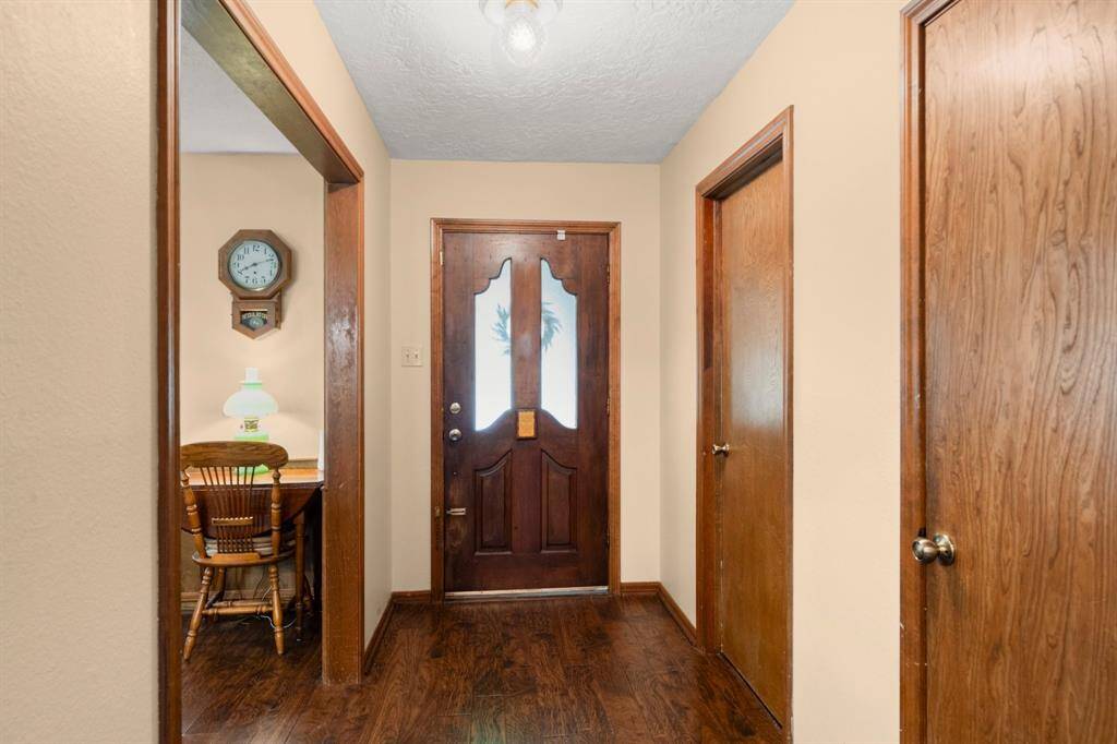 Neutral paint and cased wood openings to the kitchen and family room.