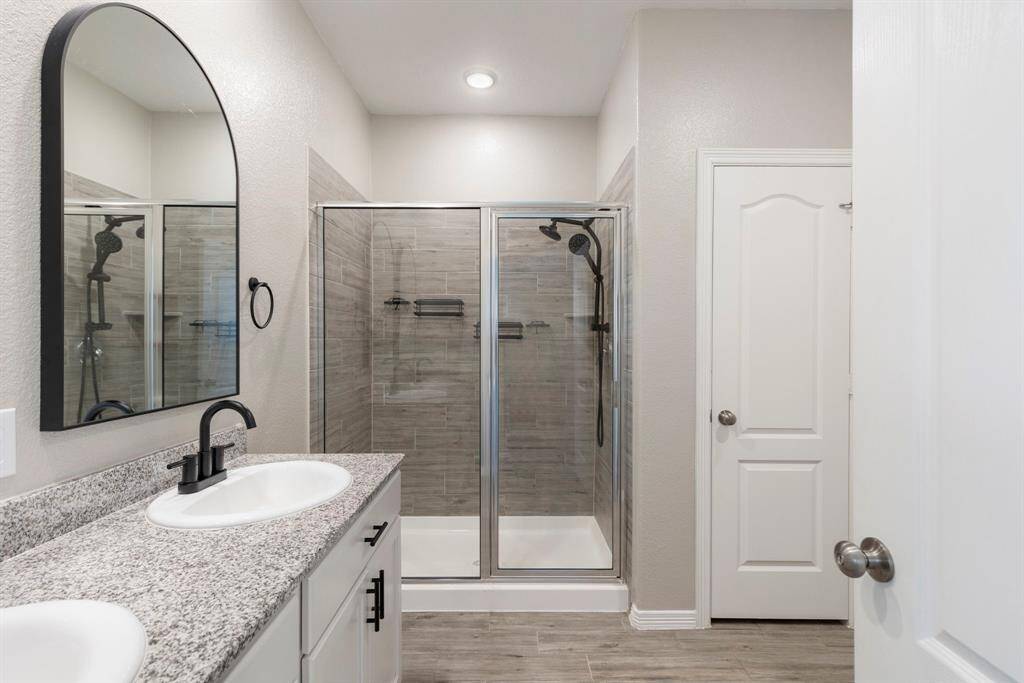 Primary bathroom features double sinks, updated counters, tile flooring and more.