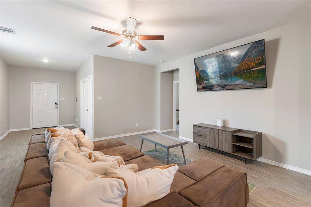 Family room features tile flooring and spacious layout open to kitchen, great for entertaing larger group.