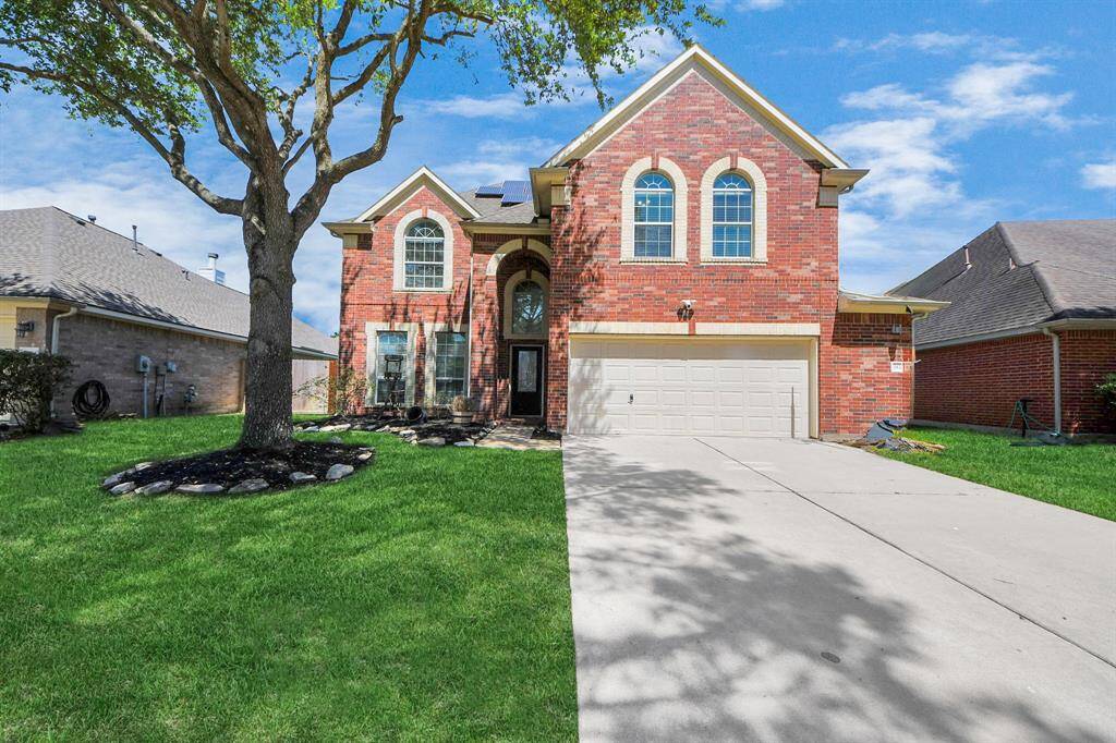 Discover your dream home at 24730 Cobble Canyon Ln! This charming residence features a stunning brick exterior, lush landscaping, and an inviting front entrance, perfect for family living.
