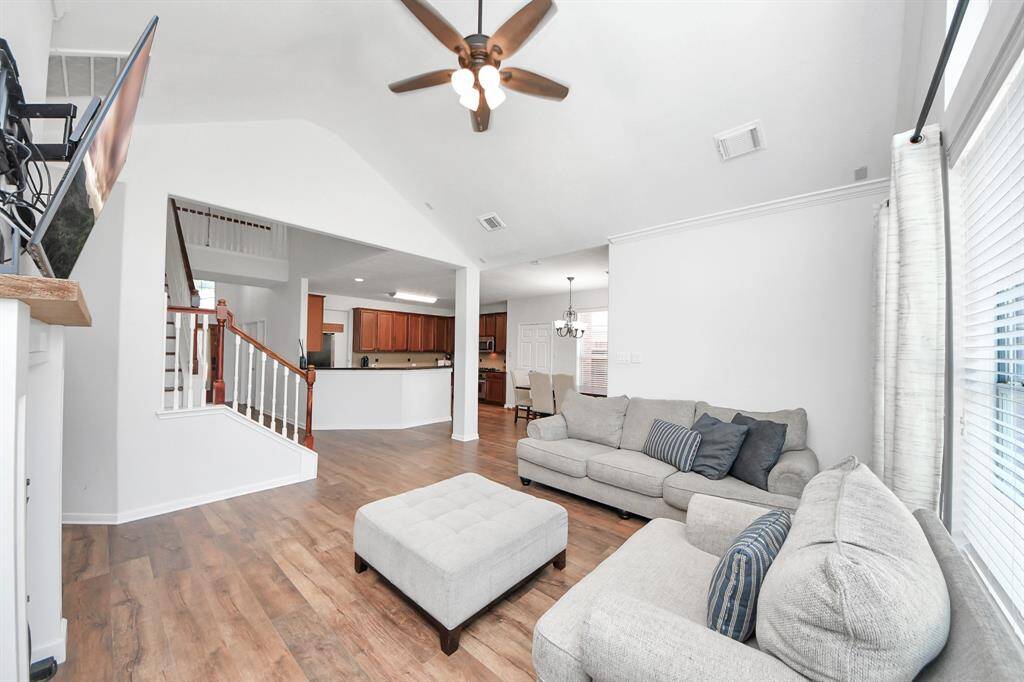 Living room with vaulted ceilings and a ceiling fan!